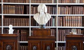 Bust on display in the Armagh Robinson Library with a row of books behind it