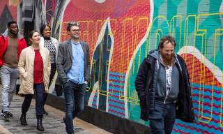 Group enjoying a street art walking tour with Seedhead Arts