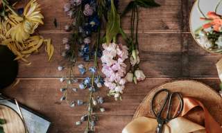 Photograph of a table adorned with floral crafting items