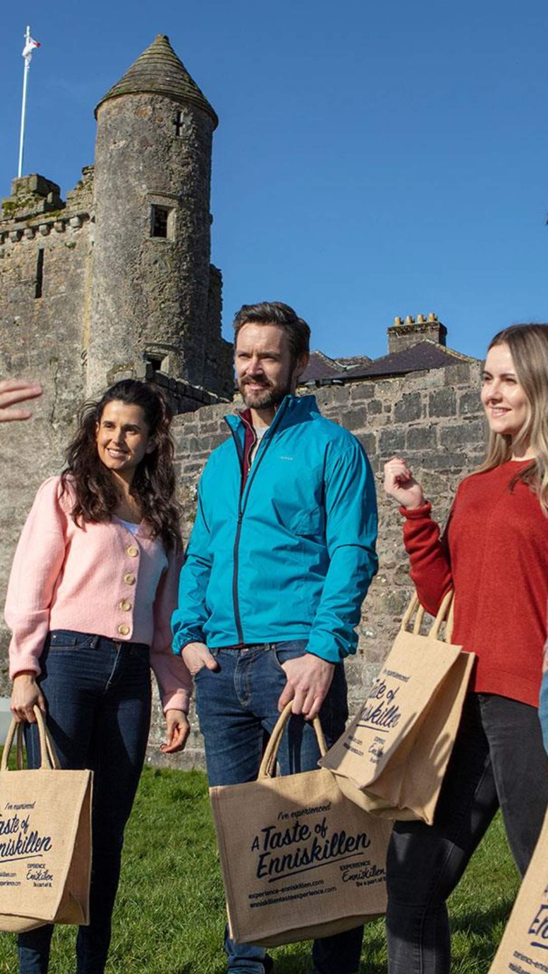 A group in the sunshine outside Enniskillen Castle enjoying an Enniskillen Taste Experience tour.
