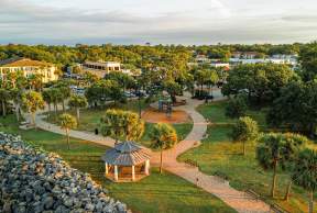 An aerial view of Neptune Park and Pier Village on St. Simons Island, GA.