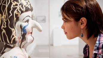 Young girl staring at a sculpture at the Nanaimo Art Gallery.