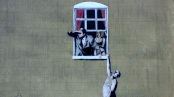 Banksy's 'Well Hung Lover' on Park Street, central Bristol