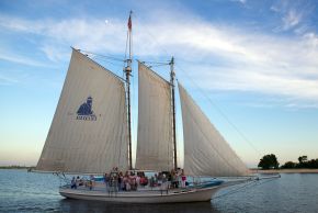 A Biloxi Schooner sails on the Mississippi Sound at sunset