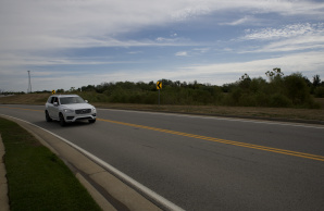 White SUV driving on Interstate