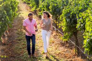 Couple walking in vineyard wide