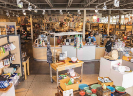 Interior of Boelter Superstore in Milwaukee, featuring wide aisles filled with kitchenware, cookware, and culinary tools, with shelves and display tables showcasing colorful bowls, utensils, and gift items.