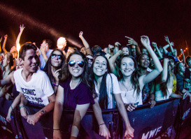 A group of people at the front row of a music performance