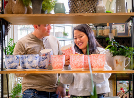 couple looking at colorful plant pots