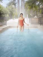 A woman entering a mineral bath at Glen Ivy Hot Springs in Corona, CA