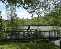 Cyclists ride their bikes along a boardwalk in one of Knoxville's greenways.