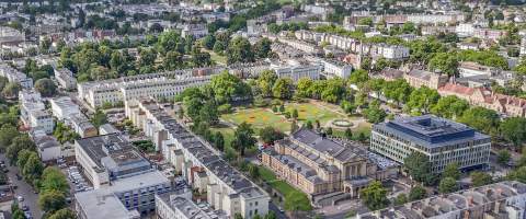 Aerial view of Cheltenham Town Hall and Imperial Gardens, Cheltenham and surrounding areas of the town.