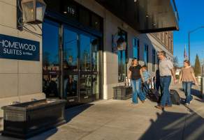 A family enters the Homewood Suites hotel
