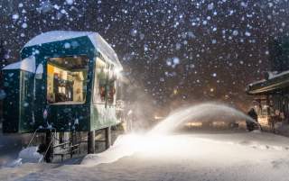 Guy snow blowing with snow falling at an Alta lift