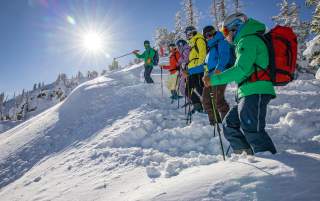 Skiers enjoy a beautiful powder day on the Wasatch Interconnect Tour