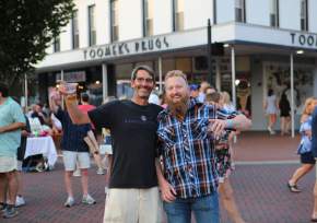 two friends at Cheers on the Corner in front of Toomers Drug Store