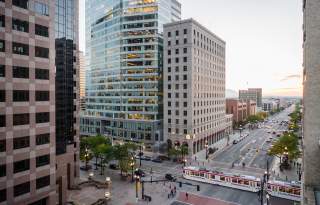 View of Salt Lake City main street with Trax light rail on the street and and early sunset sky