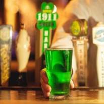 A pint of Green Beer on a Bar Counter