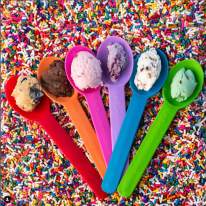 6 spoons all different colors with a scoop of ice cream sitting on each. Laying in a pile of sprinkles