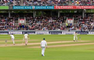 Cricket Match taking place in front of a crowd at Emirates Old Trafford