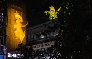Manchester illuminated monsters on the side of Harvey Nichols and Selfridges for Halloween