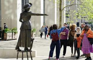 Walking tour group at Emmeline Pankhurst statue in St Peter's Square