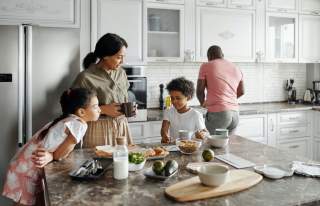 Family cooking in kitchen with food on counter