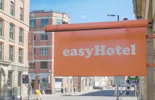 Orange easyHotel sign in Manchester city centre
