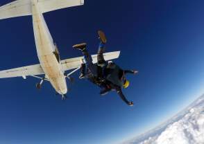 Two skydivers jumping out of a airplane in Perris, CA