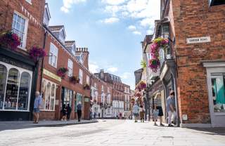 Street scene of Bailgate in Lincoln with shopfronts on sunny day