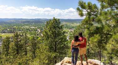 Hikers enjoying the scenic overlook of rapid city from the trails of skyline wilderness area