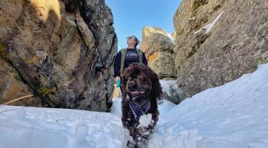 person hiking nemo rock maze in the winter with dog in the black hills