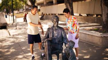couple exploring the abraham lincoln statue, part of the city of presidents tour in rapid city, sd