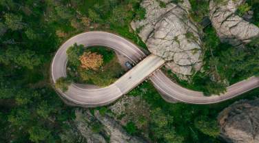 Drone shot above the pigtail and mountain tunnel of iron mountain road in the black hills