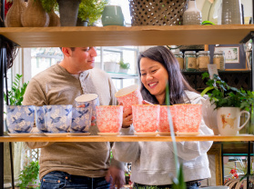couple looking at colorful plant pots
