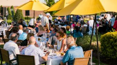 Outdoor patio dining under yellow umbrellas