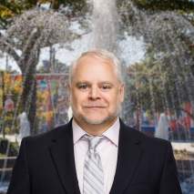 Scott Powers Headshot with city background