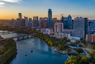Aerial view of the Austin downtown skyline from the east, with a view of Lady Bird Lake.