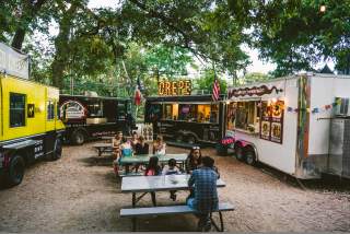 People dining near food trailors at the Rainey Street Food Truck park