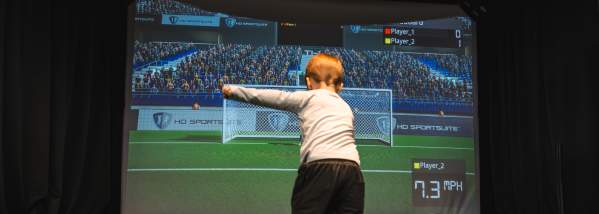 Child Kicking Ball in Simulator Bay