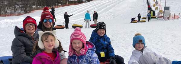 Kids snowtubing in winter