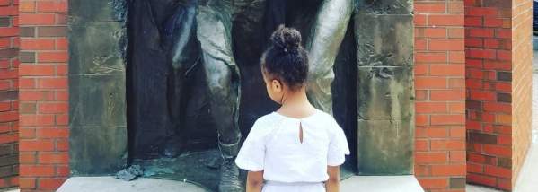 Child Standing in front of Jerry Rescue Monument