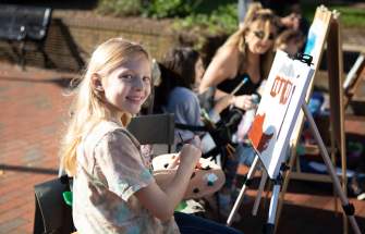 Girl smiling & painting