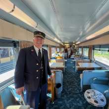 train conductor inside one of the twin sisters train cars at Northern Central Railway
