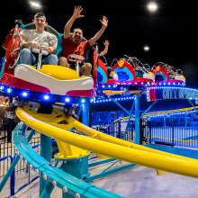 family on an indoor roller coaster