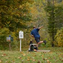 Man throwing disk golf at Rotary Park