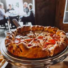 pizza with people in the background