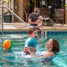Mom and son playing in a pool