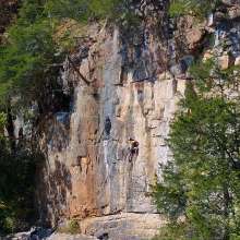 Zoomed out shot of kings bluff with climber.