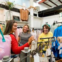 three ladies shopping in a boutique